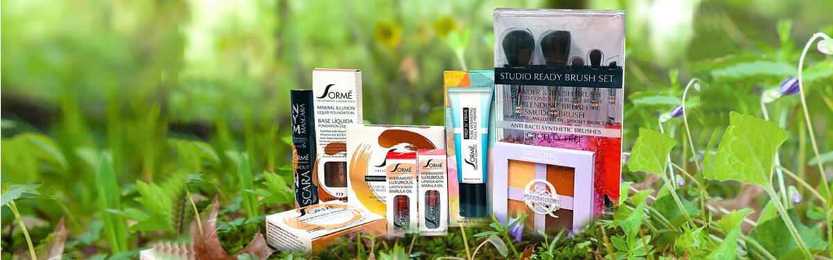 Various makeup products displayed outdoors on grass, including brushes, lipsticks, and eyeliners.